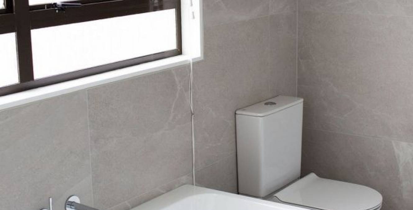 Modern floor to ceiling tiled bathroom